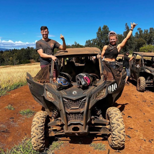 a man riding a motorcycle down a dirt road