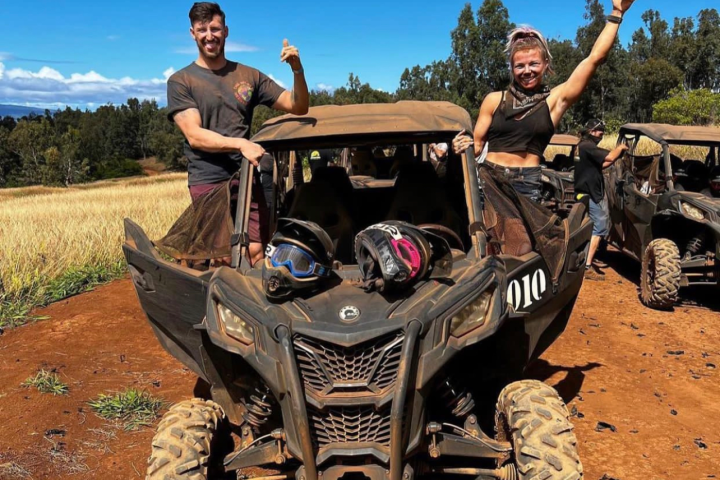 a man riding a motorcycle down a dirt road