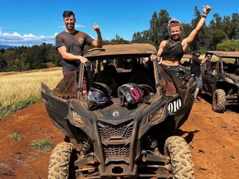 a man riding a motorcycle down a dirt road