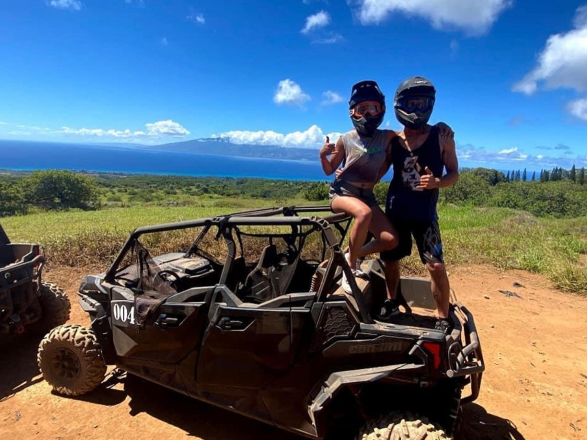 a man riding a motorcycle down a dirt road