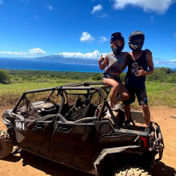 a man riding a motorcycle down a dirt road