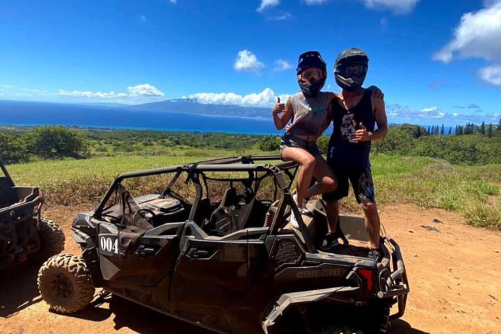 a man riding a motorcycle down a dirt road